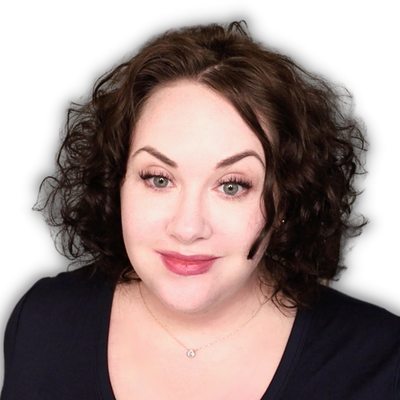 White woman with dark, curly, shoulder-length hair, green eyes, and berry lip stain
